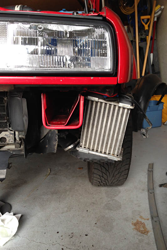 The air-to-air heat exchanger for the supercharger sits in the left front wheel well. The oil cooler has a similar air path as the intercooler.