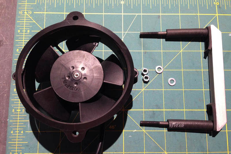 I created an 1/8" neoprene gasket to sit between the fan body and the cooler. On the opposite side of the cooler, an aluminum C channel clamps the fan in place with two M5 x 90mm screws and locknuts.