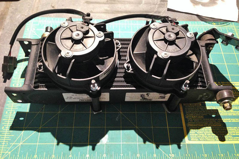 Here are the fans mounted on the back side of the cooler — they are puller fans. Rubber fuel line slipped over the long mounting screws prevents metal to metal contact.