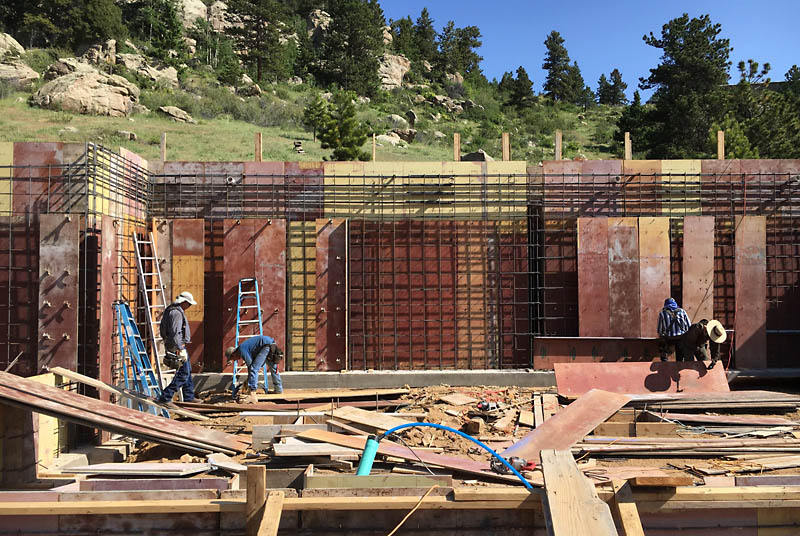 The north wall is shown here. It is 14 feet tall. Workers are beginning to enclose the steel rebar with the second side of the forms.