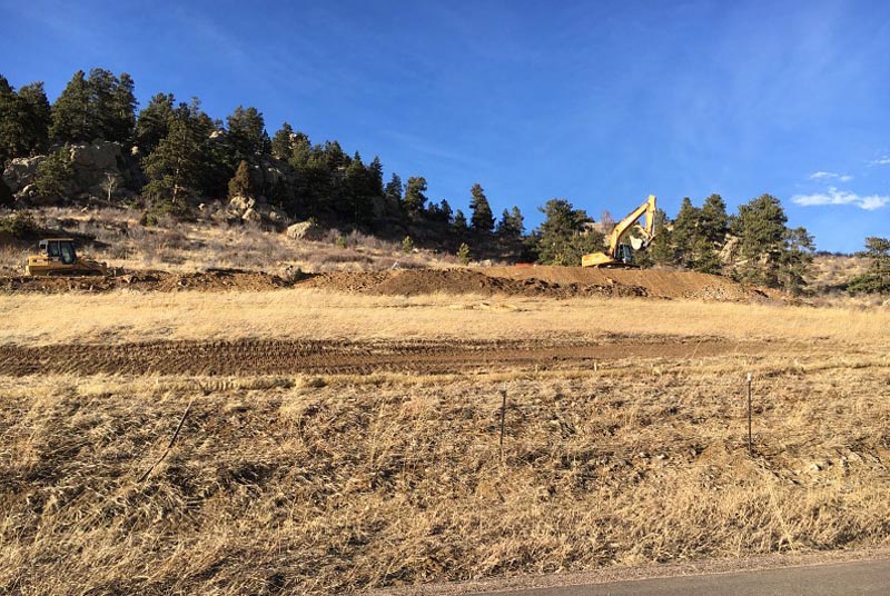 The excavators have just made it up to the house site and have begun to carve out a spot in the hill for the house. All that (mostly) rock was used to make the pan in front of the garage.