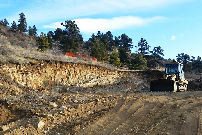 Here the cut for the house is only about eight feet deep. The light band of hard granite in the far corner required a hydraulic hammer to break it up.