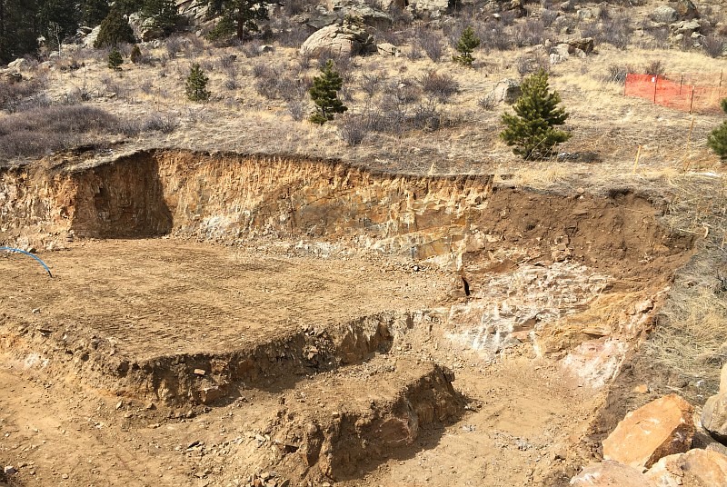 Here is the finished cut for the house. That back wall is 15 feet tall. The cuts in the foreground are three feet deep to put the footings below the frost line.