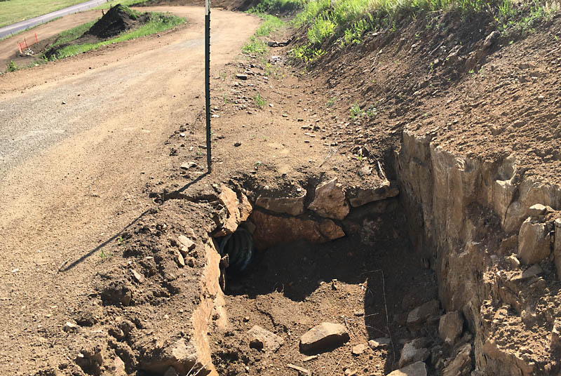 This culvert is just below the hammerhead and diverts water to an exit on the other side of the driveway.