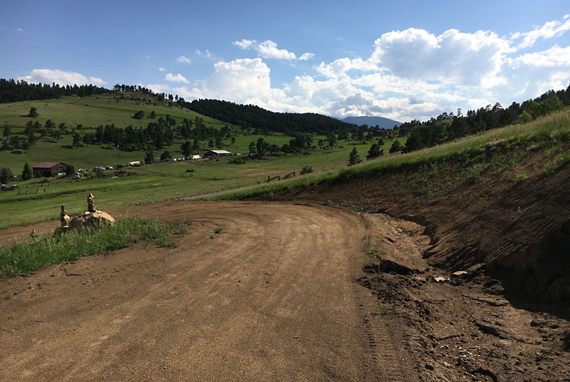 Continuing down hill, the driveway makes a hairpin turn to the south and back east.