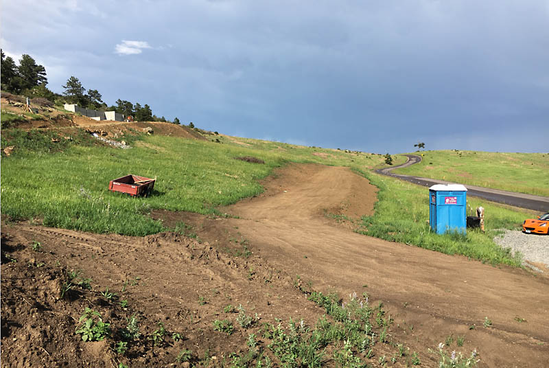 A model airplane runway runs parallel to the road with access from the bottom of the driveway. It is about 350 feet long. This is not the final grade — it will be straightened and further levelled in the near future.