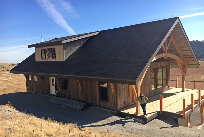 Here is a view of the back of the house showing the corrugated steel on the sides of the shed dormer: the dormer roof has architectural shingles on it.