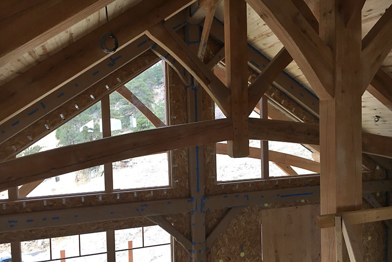 All the oak beams against the far wall are covered in paper. The ridge beam is 22 feet above the floor. 