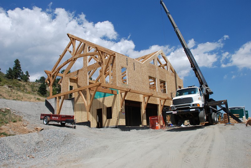 After the SIPs are assembled from smaller units, wall panels are lifted into place by a crane.