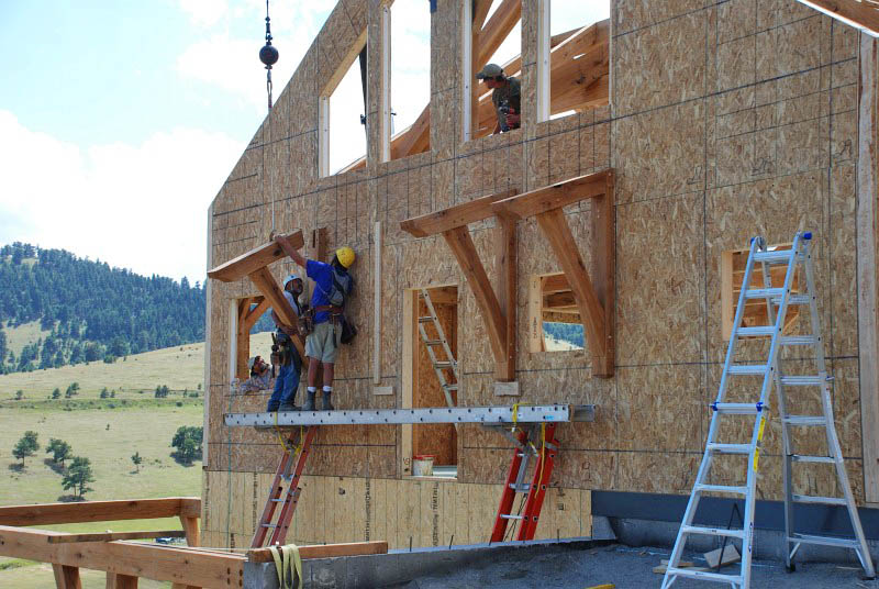 These are the braces that will hold up a small roof above the east door from the laundry room. A 4" thick plate is secured with long screws that go through the SIPs into the frame. Then the rafter and brace are attached to the vertical plate with 1" dowels.