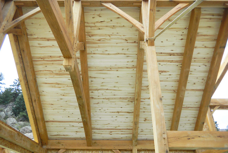 Before the roof panels are set, a 1" x 5" aspen tongue and groove ceiling is attached to the rafters from up top.