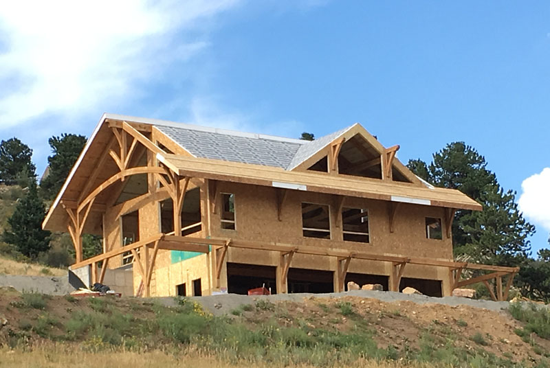 The first course of roof SIPs are visible on the south side of the house. The rest of the roof is covered in the vapor barrier that sits above the aspen ceiling.