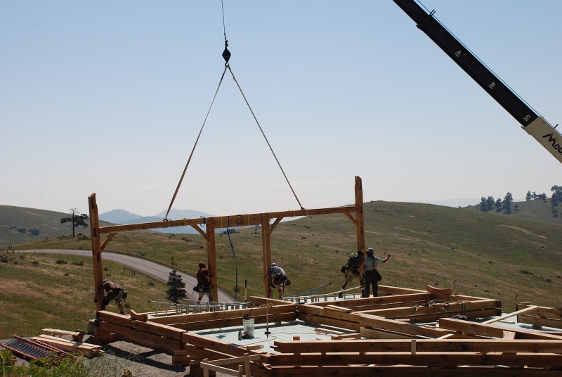 The posts of bent 6 are being slotted into the holes in the deck.