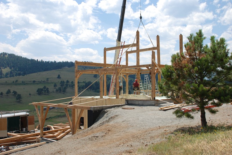 Another view of the first 3 bents installed. The post and beam that supports the deck over the east carport is also visible.