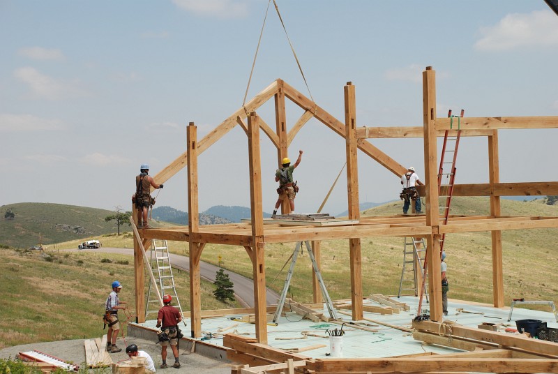 The rafters drop into place and Matt signals the crane to to hold position.