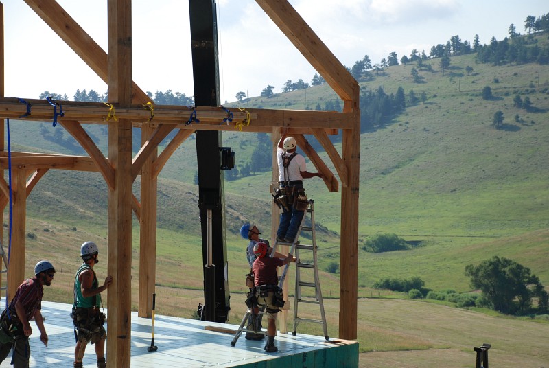 Jaime is lining up a brace as bent 2 is lowered into place. A temporary strongback is strapped to the middle of the bent.