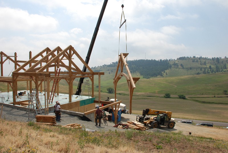 Bent 1 is lifted off the ground below and flown into place by the crane. This assembly weighs about 6,500 pounds.