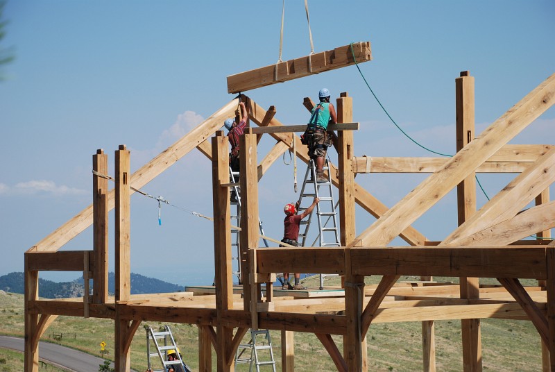 The first ridge beam is flown into place.