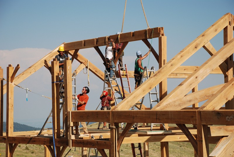 The second ridge beam is flown into place. The middle post on bent 5 twisted as it dried and took some time to seat in the first two ridge beams. <span class='myGreyFont'>[End of series.]</span>