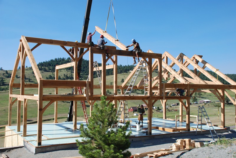 Darby and Jason guide the first rafter for the shed dormer into place.