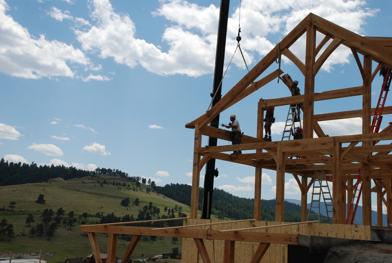 The second rafter that forms the south gable is lifted into place.