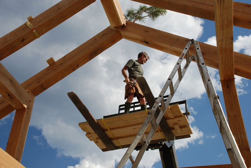 I nailed a bough to the peak of the gable, a tradition originating with the Scandanavians that celebrates the frame's completion. I'm wearing my Utilikilt (<a href='https://www.youtube.com/watch?v=-Hzh1BPmFp4' target='_blank'>hand–crafted by Celtic maidens</a>) in honor of this tradition since Scandanavians are thought to have influenced the rise of kilts in Scotland.