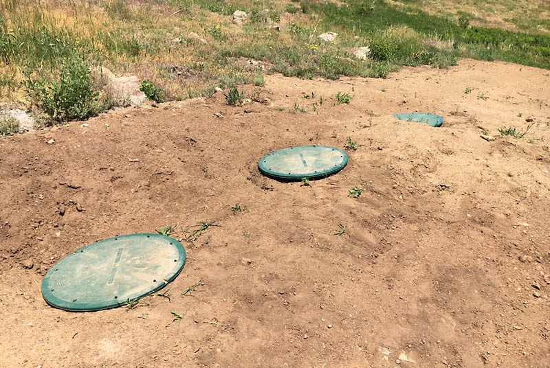 Here is a close up of the buried tanks with their green access covers just visible.