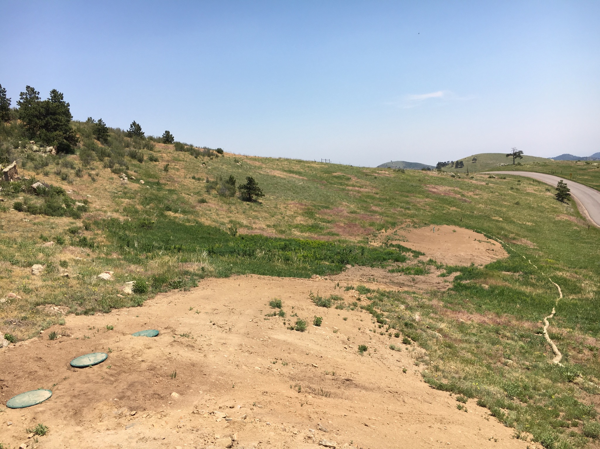 The backfilled drain field is visible in the background about 250 feet from the house. [End of series. <a href='../../index.html'>Return</a> to the New House page.]</span>