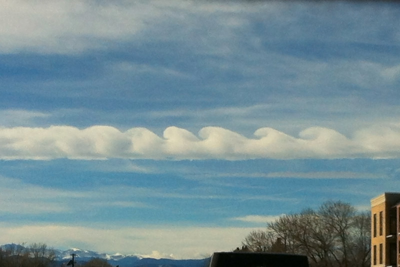 The unusual shape of these clouds is caused by a phenomena called the <a href='https://en.wikipedia.org/wiki/Kelvin-Helmholtz_instability' target='_blank'>Kelvin-Holmholtz instability</a>. The red spot on Jupiter is another example of this effect.