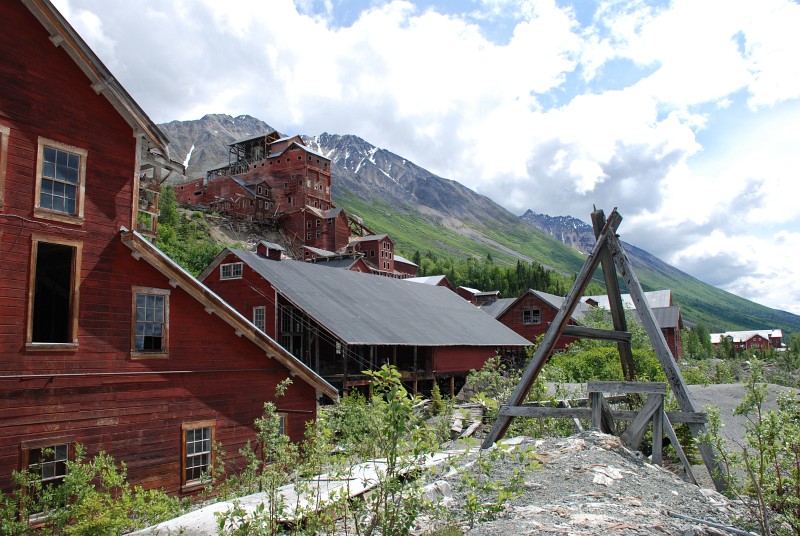 A machine shop and food store are in the foreground.