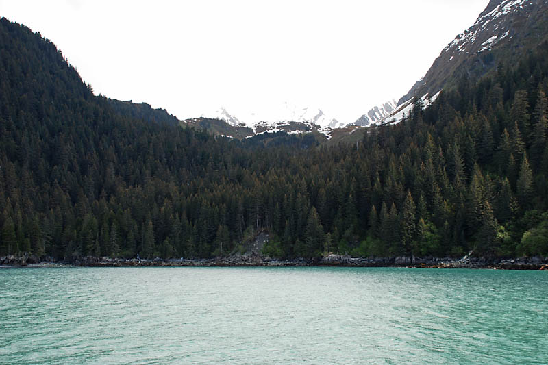 On this overcast but bright day, the snow-capped mountains fade into the sky.