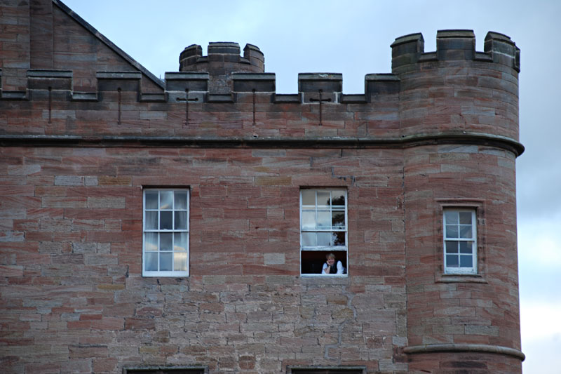 <h3>Dalhousie Castle</h3>Here's Kris looking out our third-floor window. Stone work from different eras are easily visible in this photo. Prior to its current use as a hotel, Dalhousie was used as a boy's school in the 1950's.