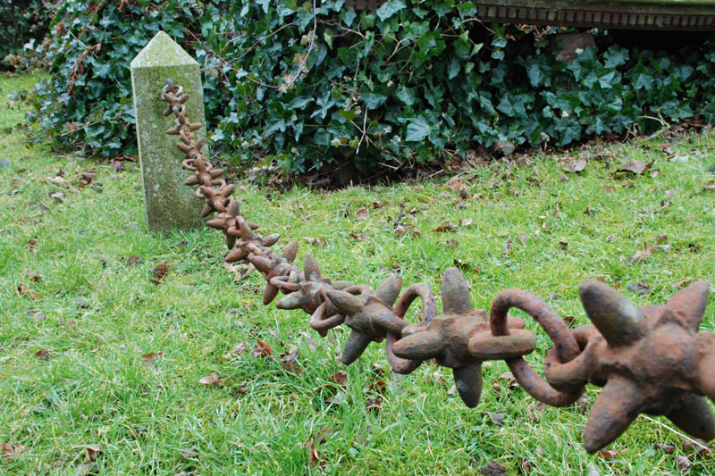 <h3>Dundrennan Abbey</h3>Even unoccupied, the abbey continued to be used as a cemetery. Here is an interesting chain that guards the front of a mausoleum.