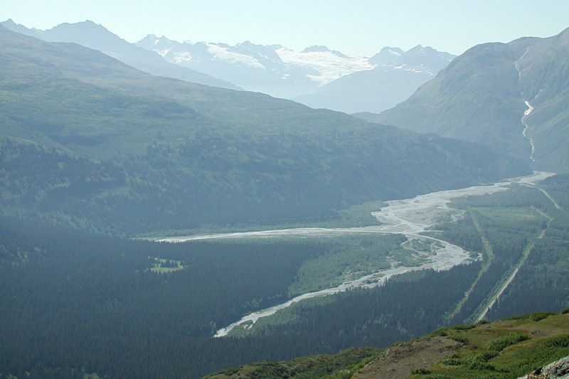 We're on our way to see Worthington Glacier a few miles outside of Valdez, Alaska. This is the the view of the valley below from the top of Thompson Pass. The elevation here is about 2,800 feet MSL. The pass is one of the snowiest places in Alaska, often recording up to 45 feet of snow in the winter. <br><br>That's the road on the right and a clearcut for the Alaska Pipeline on the left as it heads into the port of Valdez.