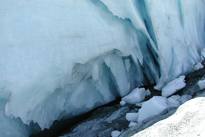 The sun and flowing water have sculpted interesting shapes into the flank of the glacier.