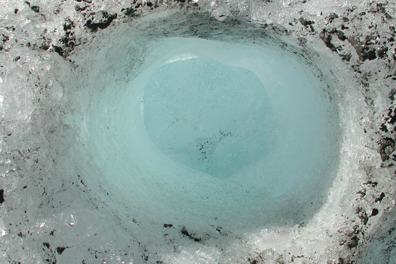 A rock probably started melting this basin in the ice, then escaped below.