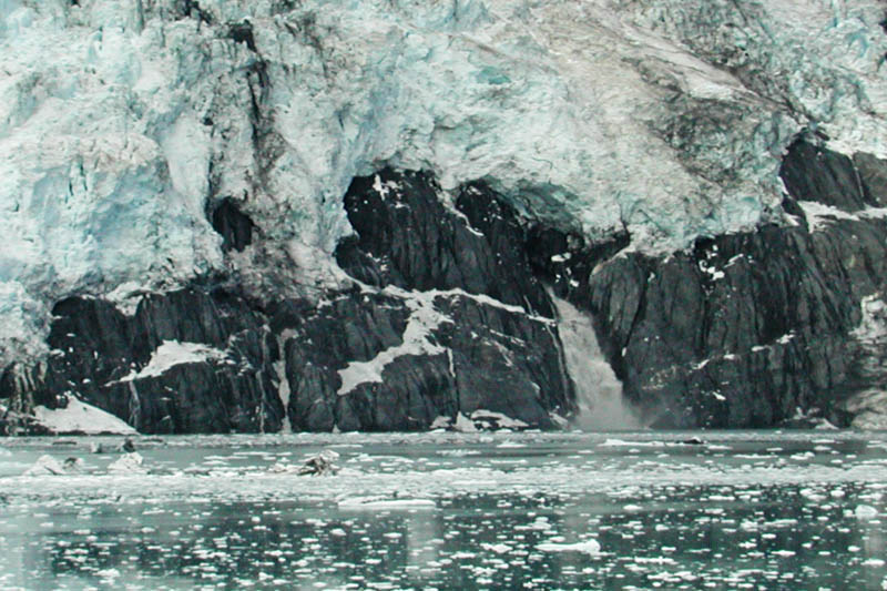 Huge amounts of water flow underneath the glacier. You can see a torrent emerging here.